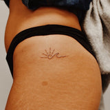 Sonne mit Welle Tattoo